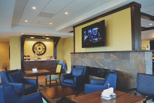 A look at a lounge area with chairs, center-table, and television in the 1912 Bistro, Sunnyside Community, Harrisonburg, VA.